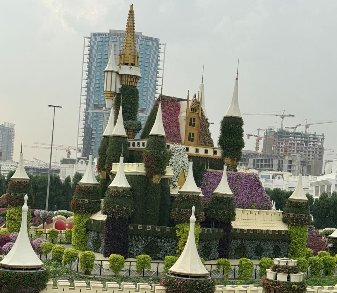 Luxury villa landscaping in Abu Dhabi featuring manicured lawns, palm trees, and modern hardscape design